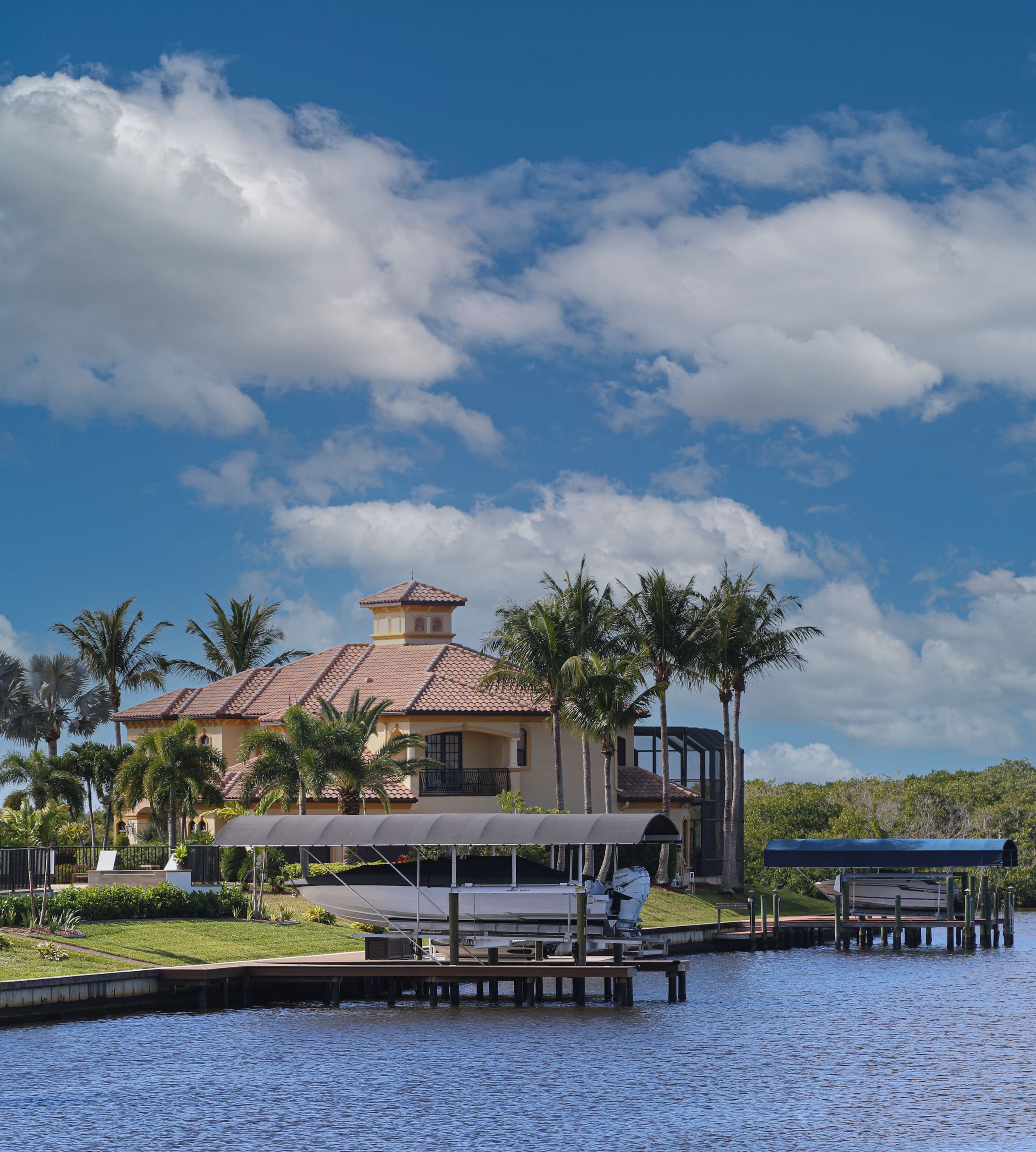 Waterfront home with a private boat dock along a calm coastal canal
